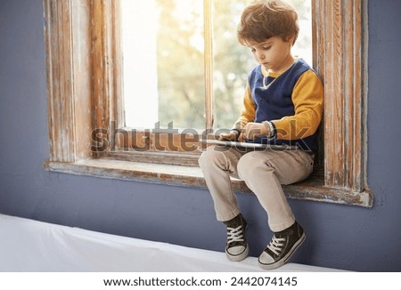 House, tablet and serious kid on internet, app or game on website for learning by windowsill. Technology, child and boy in home for education, scroll and watch cartoon online on digital electronics