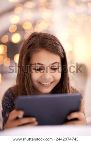 Home, night or kid with tablet for movies, playing games or watching fun videos on streaming website. Girl, house or young female child with technology to download online or social media app to relax