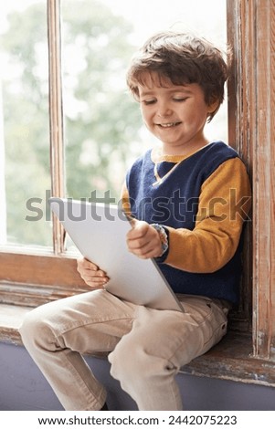 Home, tablet and happy kid on internet, app or game on website for learning by windowsill. Technology, smile and child in house for education, scroll and watch cartoon online on digital electronics