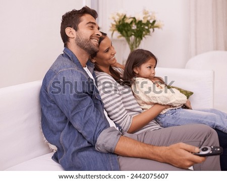 Family, remote control or fun to relax on sofa, watching tv or cartoon as bonding together in home. Papa, mama or girl child on couch to enjoy show, series or broadcast in living room at weekend Royalty-Free Stock Photo #2442075607