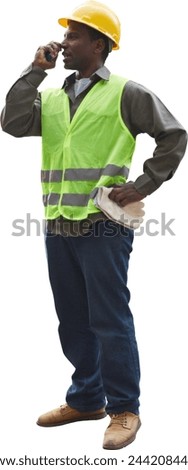 Worker of a logistics company with safety helmet and safety vest communicating with radio Royalty-Free Stock Photo #2442084431