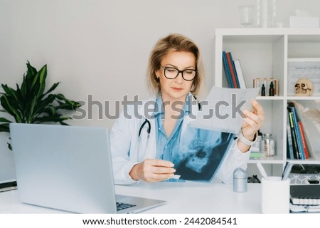 Female doctor makes online video call consult patient on laptop. Middle aged woman therapist videoconferencing for domestic health treatment. Telemedicine concept. Online remote medical appointment. Royalty-Free Stock Photo #2442084541