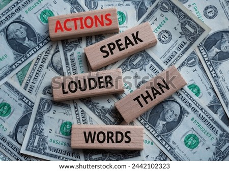 Actions speak louder than Words symbol. Wooden blocks with words Actions speak louder than Words. Beautiful dollar background. Business and Actions concept. Copy space.