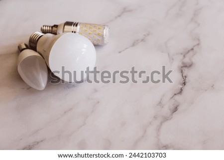 a light bulb that is on a marble counter Royalty-Free Stock Photo #2442103703