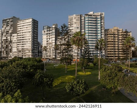 Aerial photograph of buildings on the Malecon of Miraflores, Lima, Peru with the sunset light