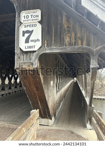 Covered bridge vehicle and pedestrian areas with vintage signage. Frankenmuth, Michigan.