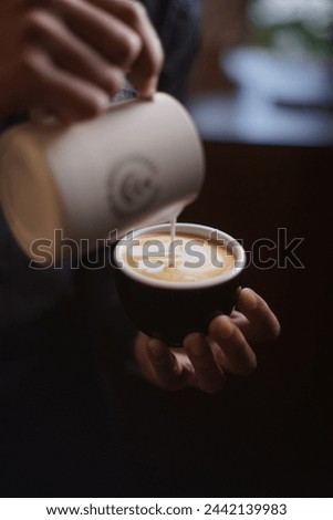 Witness barista finesse as they craft the perfect cup. Ideal for coffee lovers and cafe promotions Royalty-Free Stock Photo #2442139983