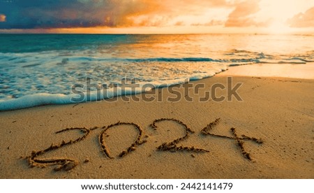 happy new year drawn on sand of beach celebration , festival holiday closeup beautiful picture the beautiful sea view.