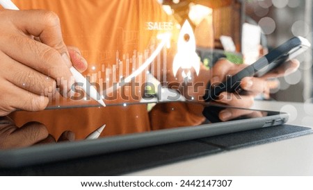 Sale growth concept. Businessman touching graph of increase in sales volume with shopping cart on virtual screen for ecommerce growth. Businessman pointing arrow graph corporate future growth plan Royalty-Free Stock Photo #2442147307