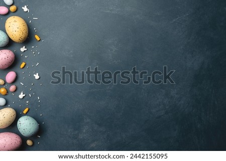 colorful Easter eggs on left of frame on a dark textured surface