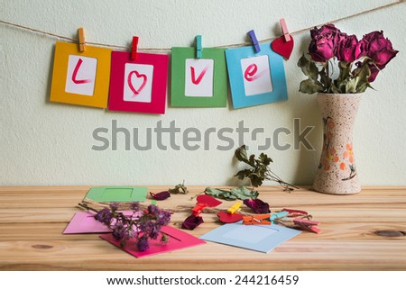 Vintage i love you write on paper paper photo frame on clothesline over grunge background, Valentine concept