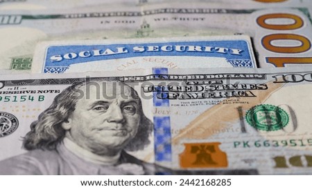 Photo of social security card with one hundred dollar bills