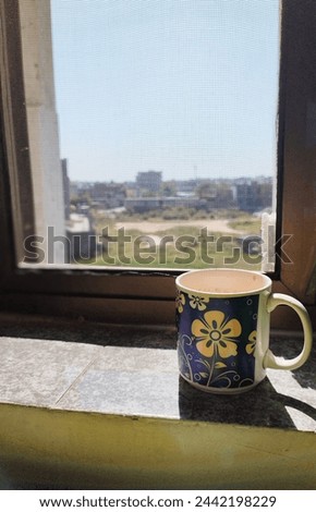 greenery view from window with a tea or coffee cup 