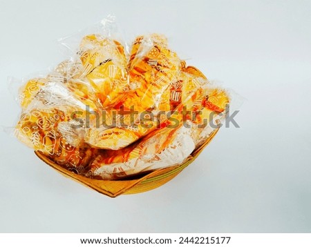 There were lots of cheese bread and sausage bread still wrapped in plastic on a woven bamboo plate. Royalty-Free Stock Photo #2442215177