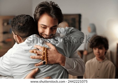 Muslim Men Greeting Each Other With Hug Royalty-Free Stock Photo #2442221075