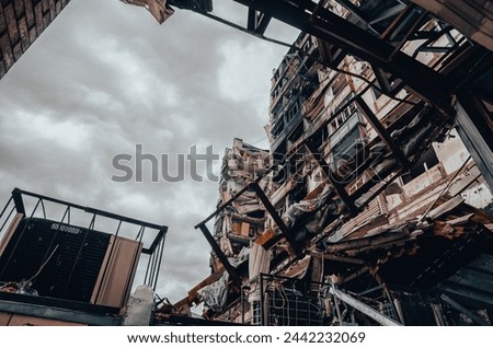 destroyed and burned houses in the city Russia Ukraine war Royalty-Free Stock Photo #2442232069