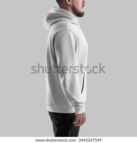 Mockup of white oversized hoodie on bearded man in dark jeans, side, textile apparel with pocket, laces, label for design, branding. Male sweatshirt template isolated on background. Fashionable sloth