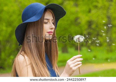 Elegant fashion model with long brown hair and natural makeup against floral background outdoor