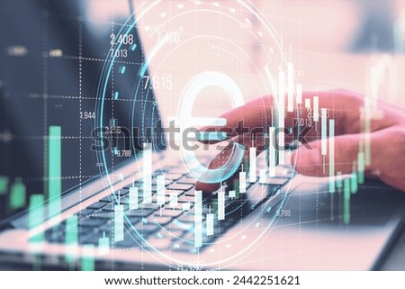 Close up of male hands using laptop with creative round ruble hologram on blurry grid background with forex chart. Online banking, cryptocurrency and finance concept. Double exposure