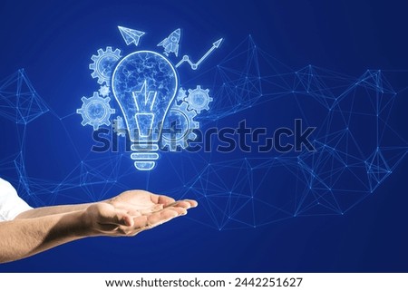Close up of male hands holding glowing blue lightbulb, cogwheel and arrow hologram on polygonal background. Innovation and creative idea concept