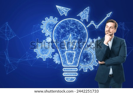 Attractive thoughtful young businessman with glowing blue lightbulb, cogwheel and arrow hologram on polygonal background. Innovation and creative idea concept