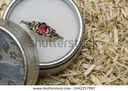 Ring in a jewelry box on background of wood chip for texture and wallpaper