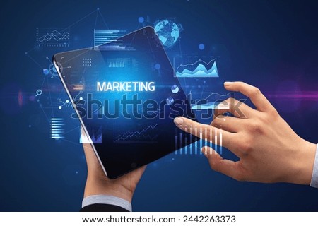Businessman holding a foldable smartphone, business concept