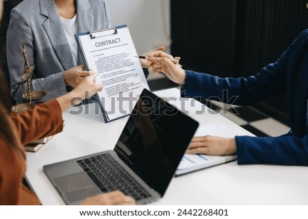 Business law concept, Lawyer business lawyers are consulting lawyers for women entrepreneurs to file copyright lawsuit with laptop and tablet at office 