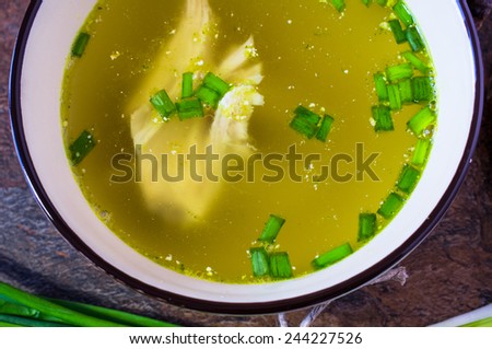 Chicken broth soup with herbs