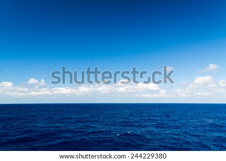 Seascape. Blue sky and white cloud. Calm sea. Royalty-Free Stock Photo #244229380
