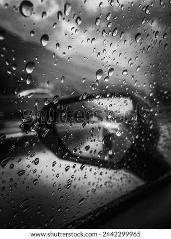 Rain drops on the rear view mirror, black white picture