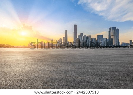 Asphalt road square and city skyline with modern buildings at sunset