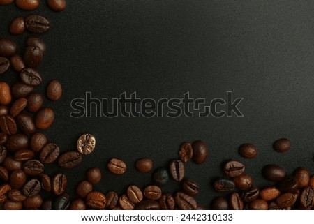 One golden coffee bean among brown ones on dark background. Concept of uniqueness