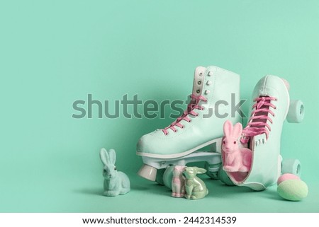 Vintage roller skates with toys bunny and Easter eggs on turquoise background