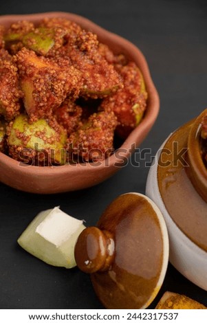 Homemade Mango Pickle or aam ka achar or Kairi Loncha in a earthen or China clay bowl, selective focus