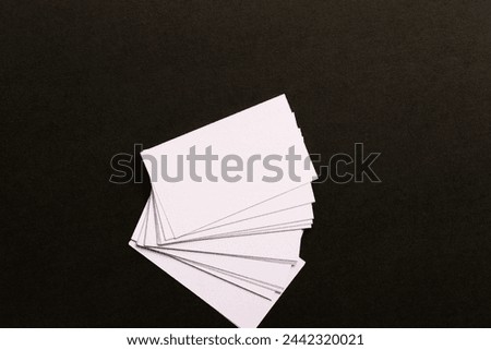 White cards lined up on a black background