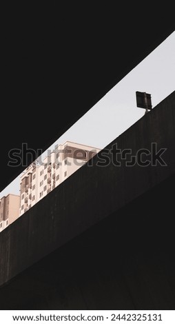 Building picture between 2 train bridges which become negative space and gives the framing effect 