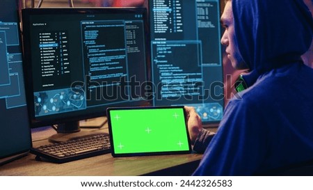 Hackers doing computer sabotage using encryption trojan ransomware on green screen tablet. Cybercriminals use mockup device to demand ransom money from victims in exchange for access to their data