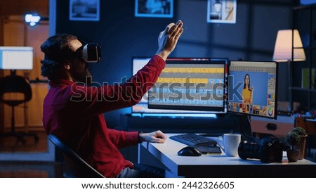 Photo editor using high tech VR goggles to look at editorial pictures taken with professional camera for fashion magazine. Freelancer browsing images using virtual reality headset technology