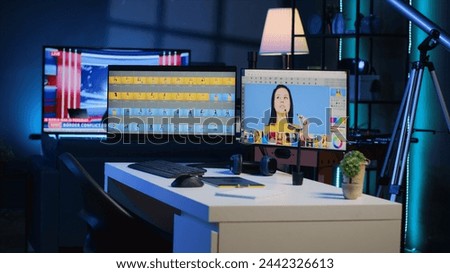 Photo processing software interface on computer screens in creative agency studio, panning shot. Image editing program UI displayed on multi monitors PC setup in photographer workspace