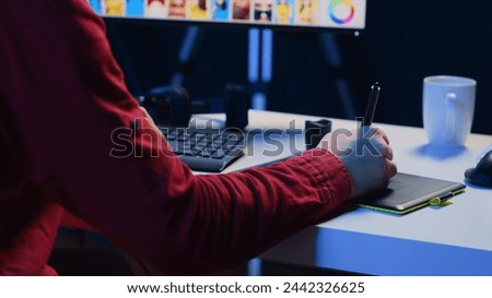 Photographer using graphic tablet to perform editing operations to correct images in creative agency. Photo editor using stylus on touchscreen device to make adjustments to photographs, close up