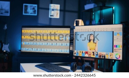 Photo retouching software interface on computer in empty blue neon lit photography studio. Photography organizing program displayed on multi monitors PC setup on multimedia agency desk, zoom out shot