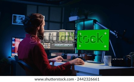 Video editor using editing software on green screen monitor to upgrade footage shot, commissioned by production teams outsourcing tasks. Freelancer videographer finishing project on mockup PC