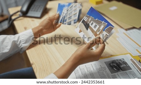 A woman examines photos of buildings as part of an indoor investigation, suggesting a focus on real estate analysis or detective work.