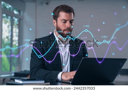 Smiling businessman in formal wear working on laptop at office workplace with smartphone and notebooks. Concept of successful business deal, agreement. Forex chart, financial graph, stock market icons