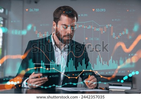 Considered businessman in formal wear signing contract holding tablet device at office room with papers. Concept of successful business deal, agreement, partnership, documents.Stock market chart icons