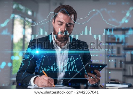 Considered businessman in formal wear signing contract holding tablet device at office room with papers. Concept of successful business deal, agreement, partnership, documents.Stock market chart icons