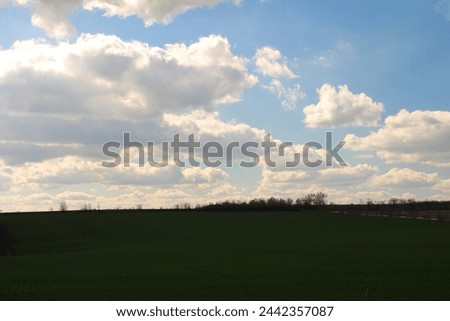 A large green field, sky