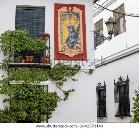 Religious azulejo tiles of Jesus Christ on a building in Andalusia, Spain.