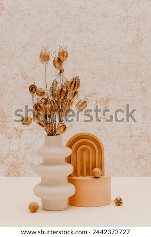 Creative composition with vase and dried flower bouquet. Ceramic vase with decorations over concrete wall background. Vase for home interior and poster, aesthetic style